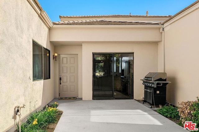 entrance to property featuring a patio area