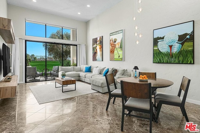 living room featuring a towering ceiling