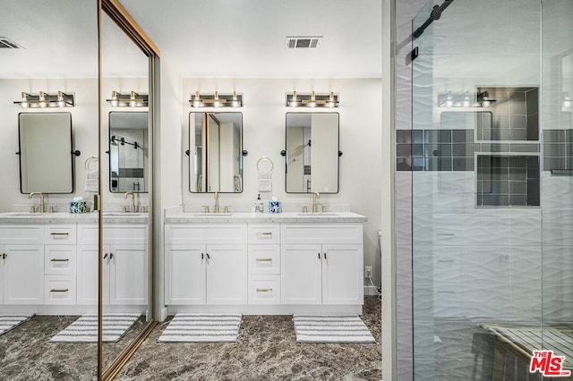 bathroom with a shower with door and vanity