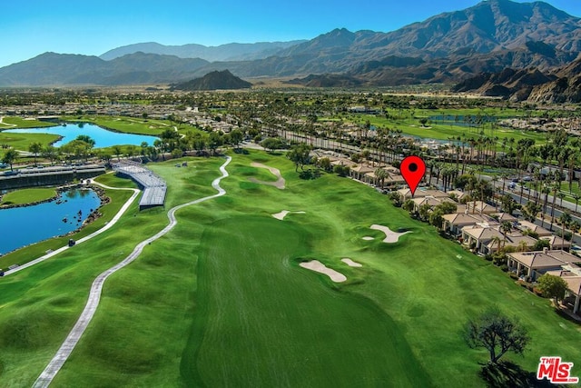 birds eye view of property with a water and mountain view