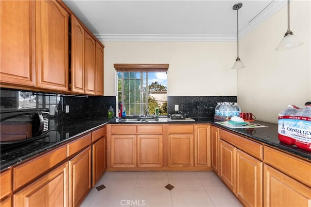 kitchen with backsplash, pendant lighting, light tile patterned flooring, sink, and ornamental molding