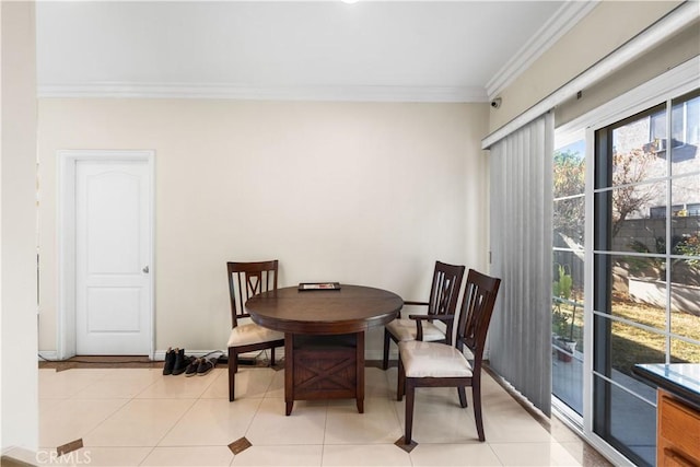 tiled dining area featuring ornamental molding