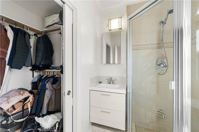 bathroom featuring vanity and an enclosed shower