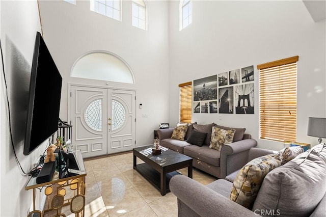 living room with light tile patterned floors, french doors, and a high ceiling