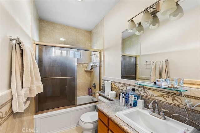 full bathroom featuring shower / bath combination with glass door, vanity, and toilet