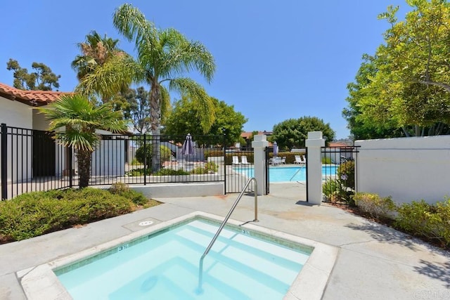 view of pool with a community hot tub