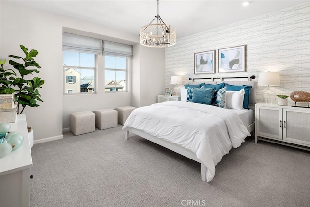 carpeted bedroom featuring an inviting chandelier