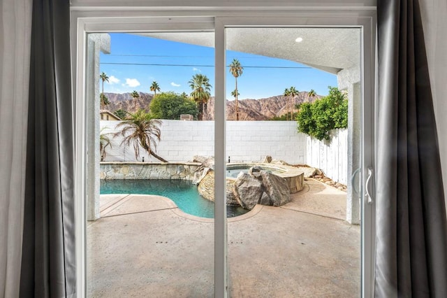 doorway to outside with a mountain view