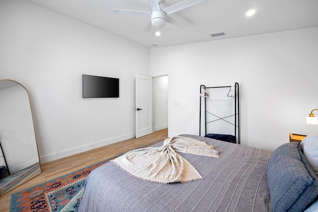 bedroom with ceiling fan and hardwood / wood-style flooring