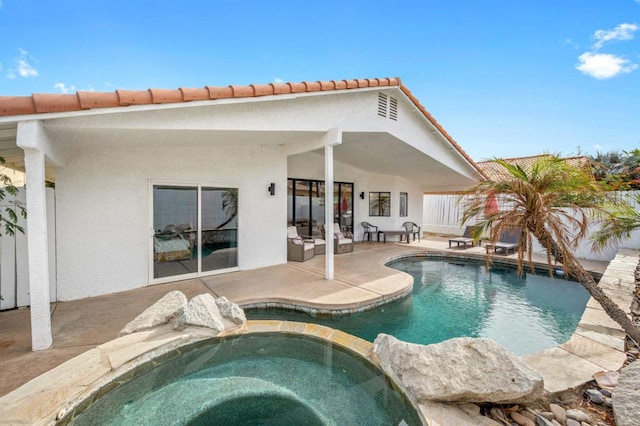 view of swimming pool with a patio area and an in ground hot tub