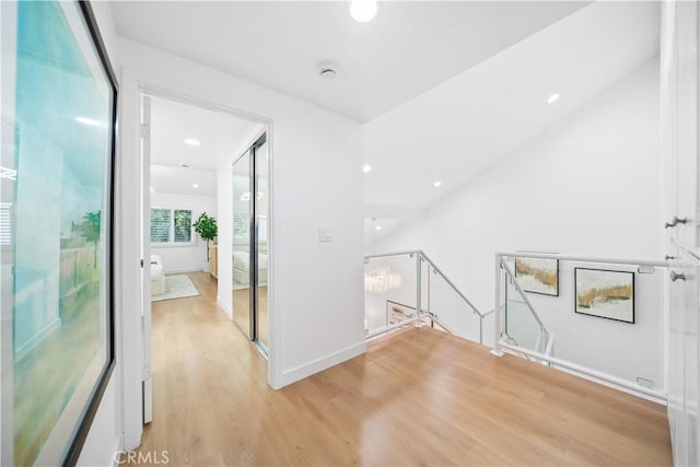 interior space featuring light wood-type flooring and an inviting chandelier