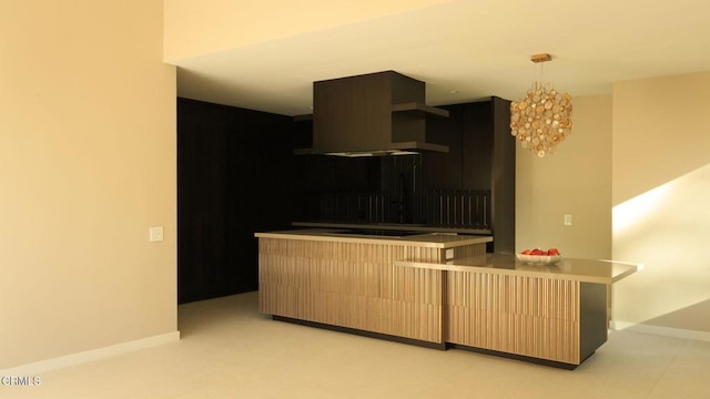 kitchen featuring an inviting chandelier, hanging light fixtures, cooktop, and extractor fan