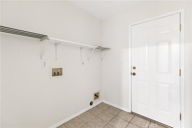 clothes washing area featuring washer hookup and light tile patterned floors