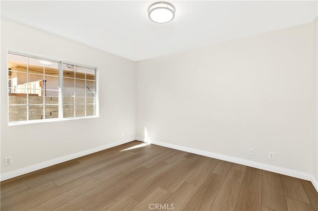 spare room with hardwood / wood-style flooring