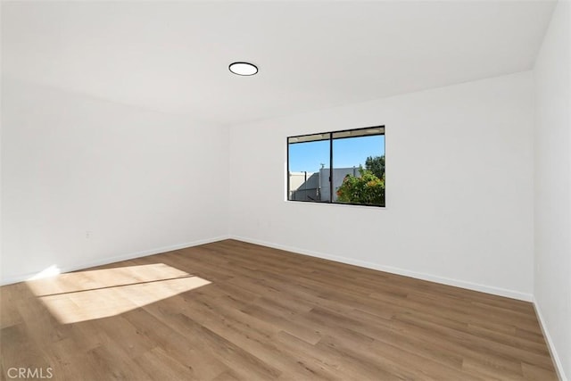 unfurnished room featuring hardwood / wood-style floors