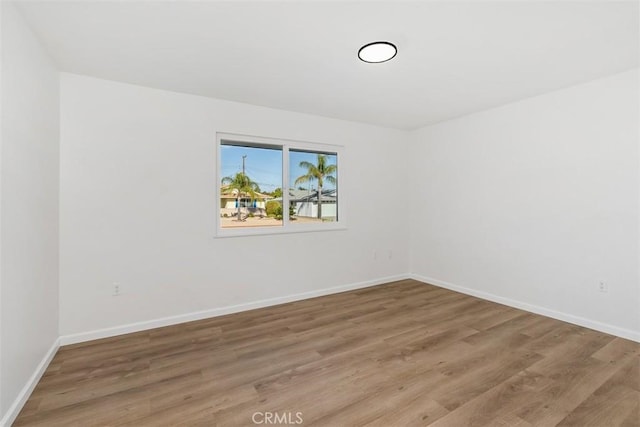 spare room with wood-type flooring