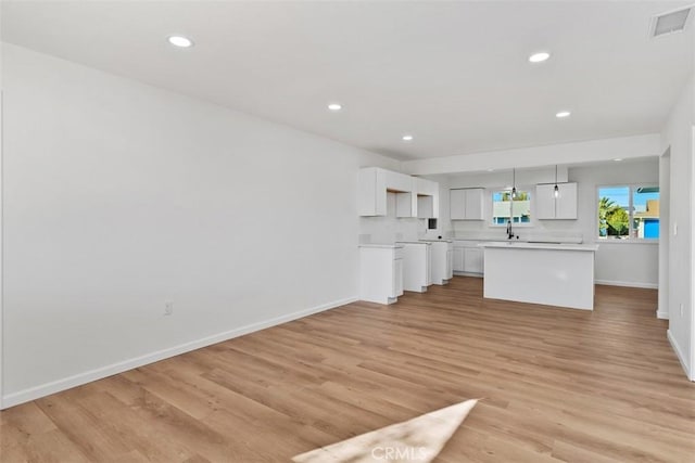 unfurnished living room with light hardwood / wood-style flooring