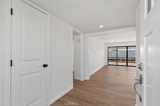 hallway with hardwood / wood-style flooring