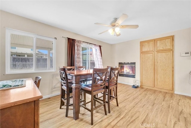 dining space featuring ceiling fan and light hardwood / wood-style flooring