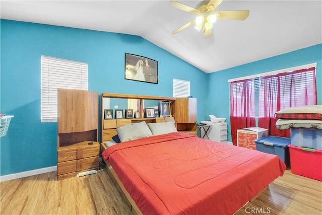 bedroom with hardwood / wood-style flooring, ceiling fan, and lofted ceiling