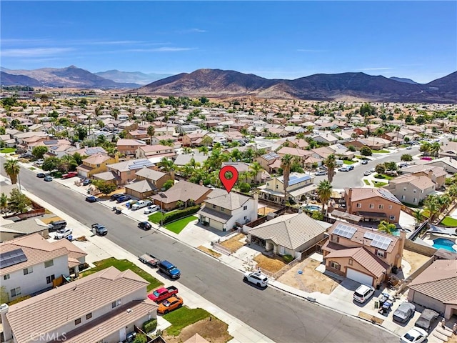 birds eye view of property with a mountain view