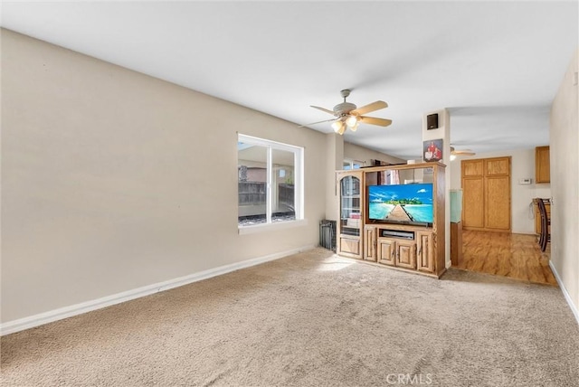 unfurnished living room with carpet flooring and ceiling fan