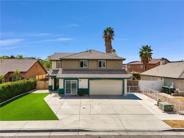 view of property featuring a front yard and a garage