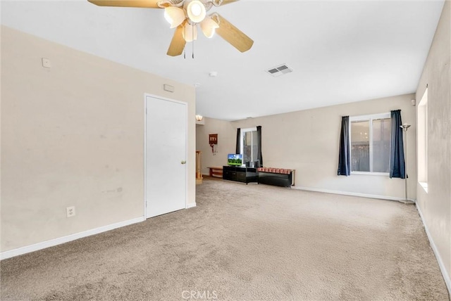 carpeted spare room featuring ceiling fan