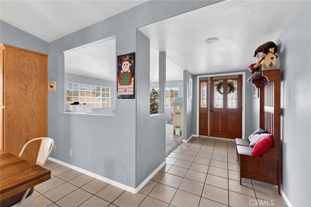 entryway featuring plenty of natural light and light tile patterned floors