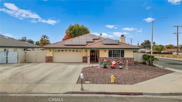 ranch-style house with solar panels and a garage