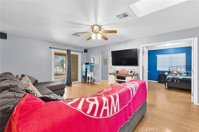 living room with ceiling fan and wood-type flooring