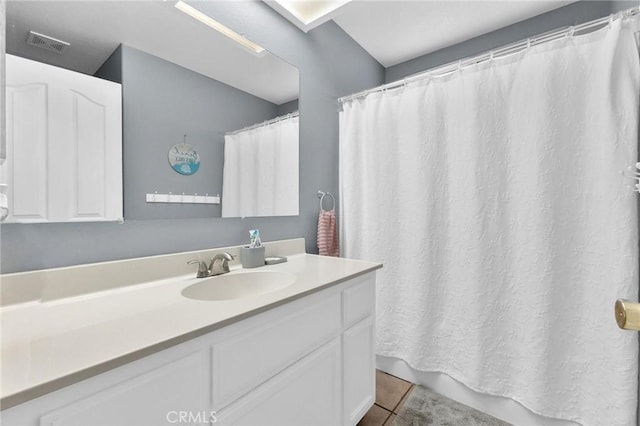 bathroom with tile patterned flooring and vanity