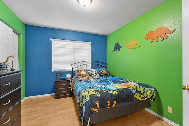 bedroom featuring light hardwood / wood-style floors and a closet