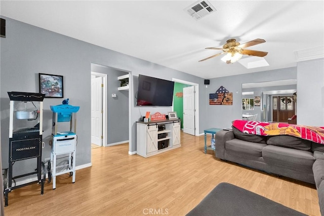 living room featuring ceiling fan and light hardwood / wood-style floors