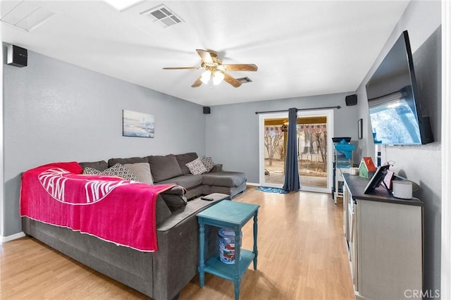 living room featuring ceiling fan and wood-type flooring