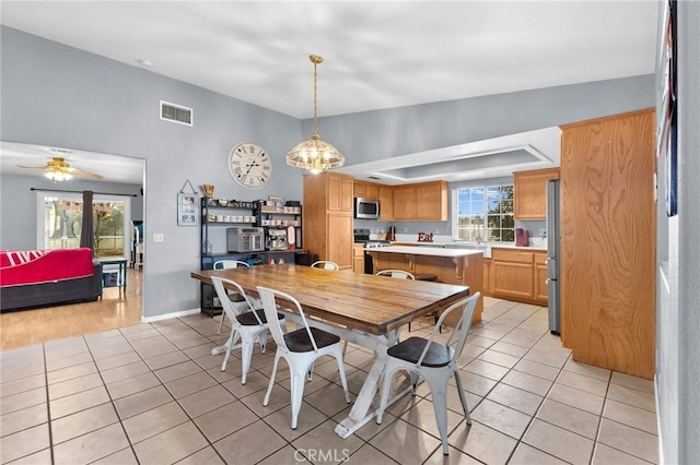 dining area featuring ceiling fan and light tile patterned floors