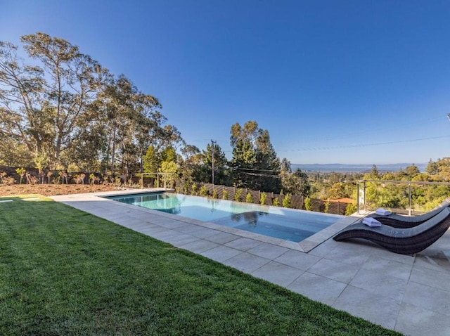 view of pool featuring a lawn and a patio area