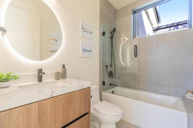 full bathroom with toilet, vanity, and shower / bath combination with glass door