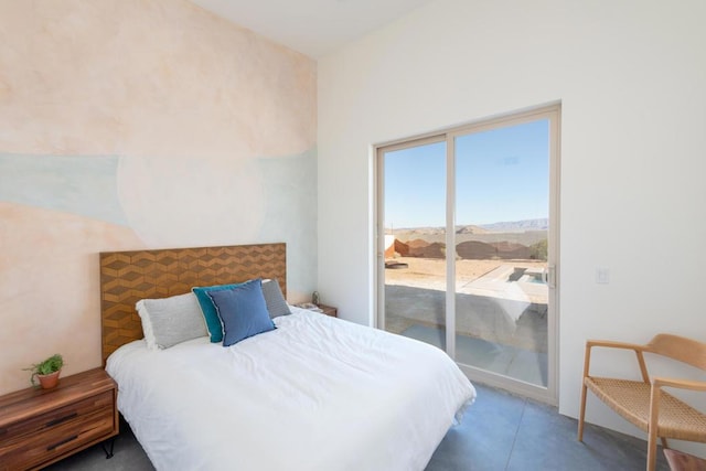 bedroom featuring access to outside and a mountain view