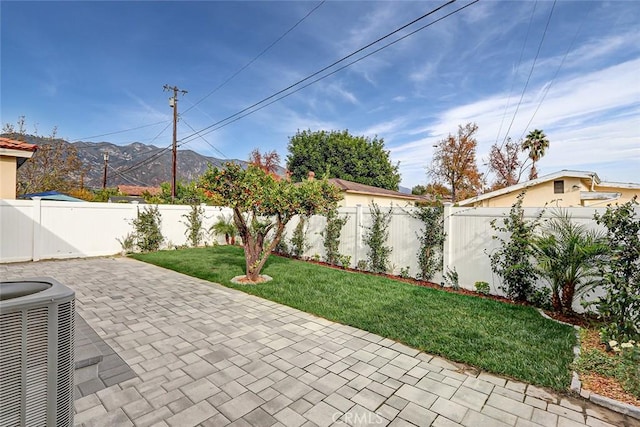 view of patio / terrace with central AC and a mountain view