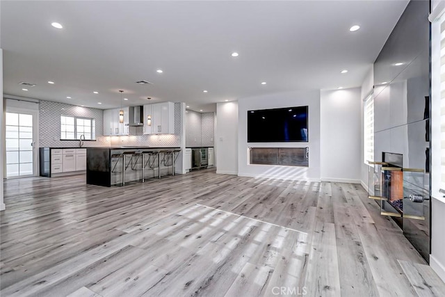 unfurnished living room featuring light hardwood / wood-style floors