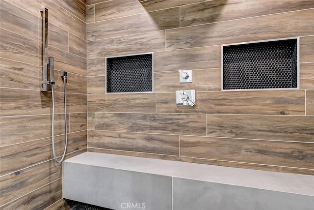 bathroom with tiled shower