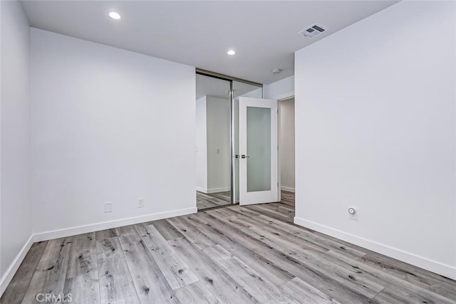 spare room featuring light wood-type flooring