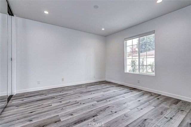 spare room featuring light wood-type flooring