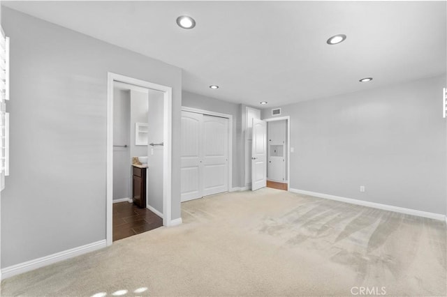 unfurnished bedroom featuring carpet flooring, visible vents, baseboards, and recessed lighting