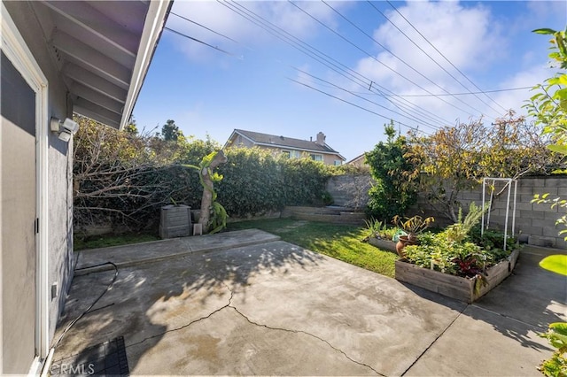 view of patio featuring a fenced backyard and a vegetable garden