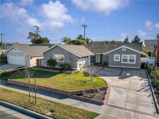 ranch-style house with board and batten siding, fence, a front lawn, and concrete driveway