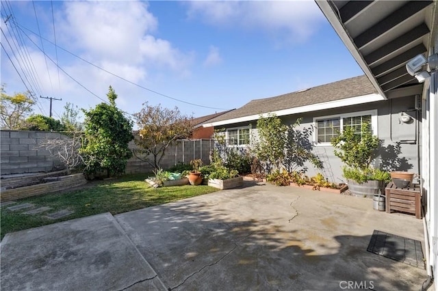 view of patio with a fenced backyard and a vegetable garden