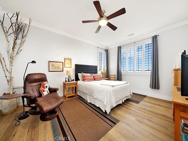 bedroom with ceiling fan, wood-type flooring, and crown molding