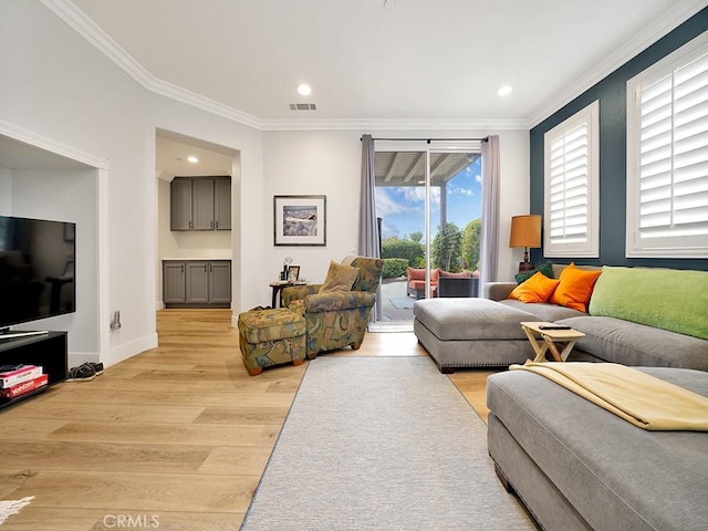 living room featuring light hardwood / wood-style floors and ornamental molding